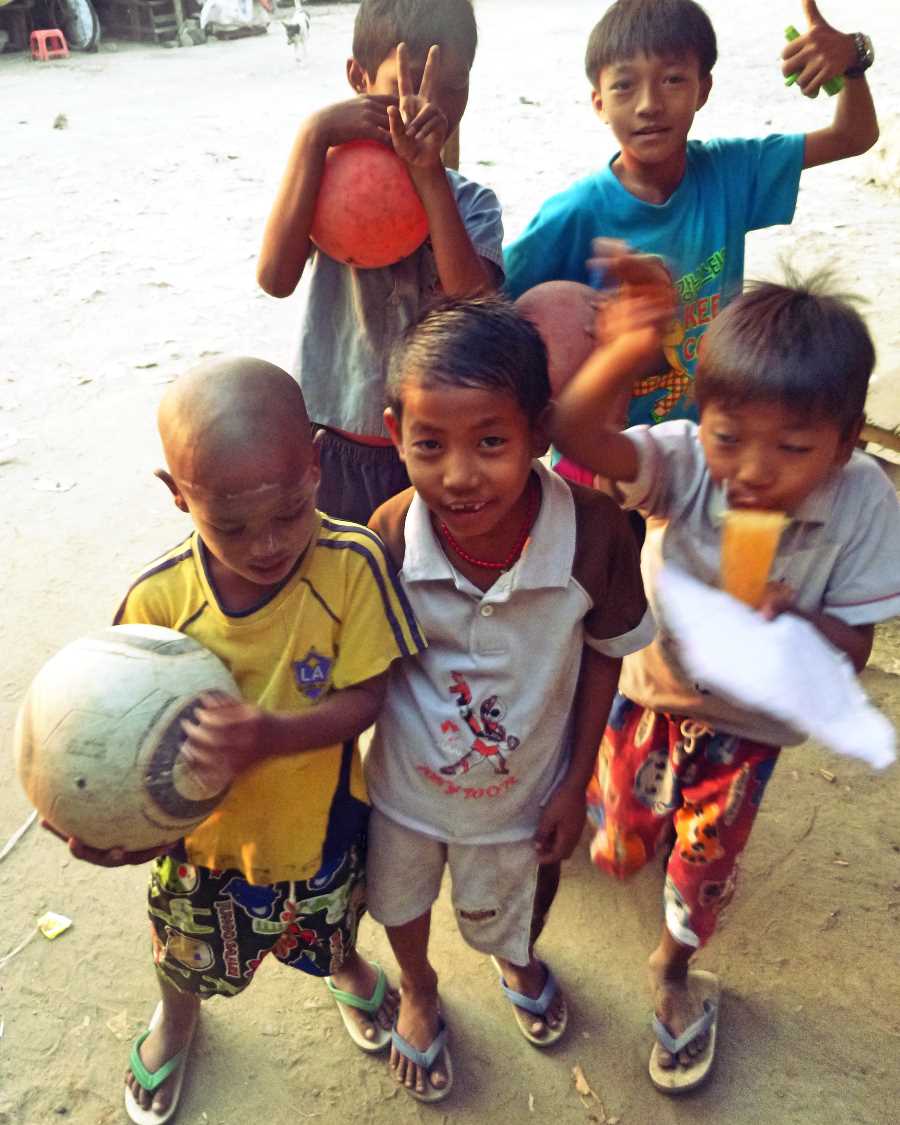 Boys pose with a football in Mandalay