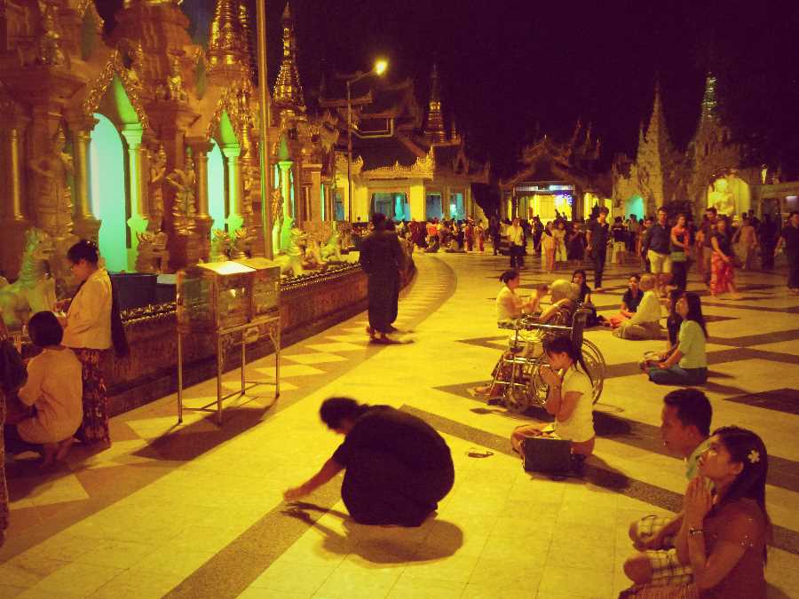 Encircling the stupa are numerous gilded buildings housing golden idols illuminated with varying degrees of flashing neon