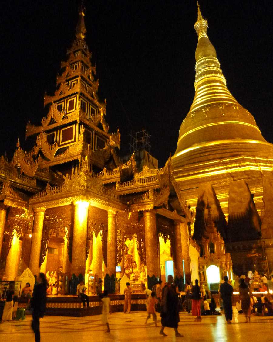 Pilgrims on their way up the steps of the pagoda, buy flowers, candles, coloured flags and streamers