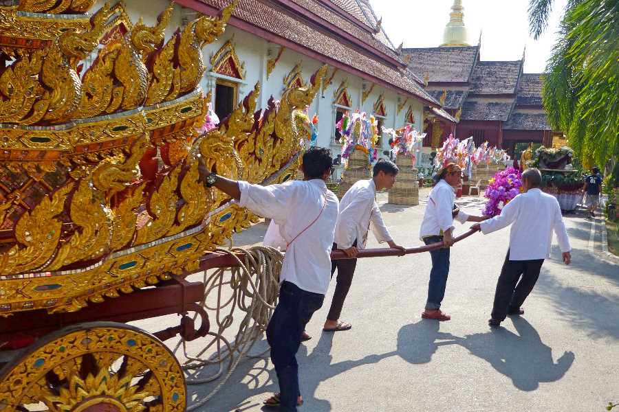People go to temple to make merit during Songkran