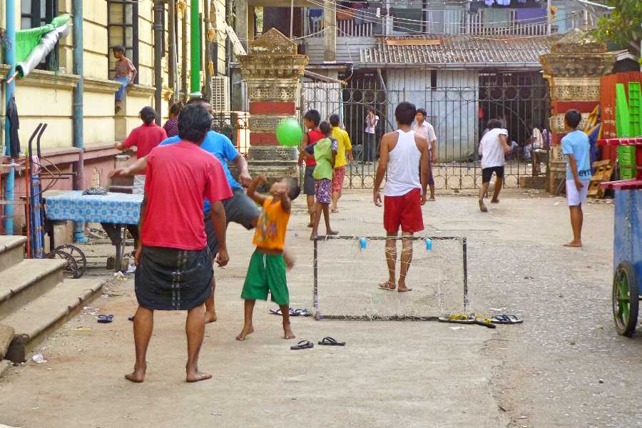 Neighbours play in the street in Yangon, Myanmar