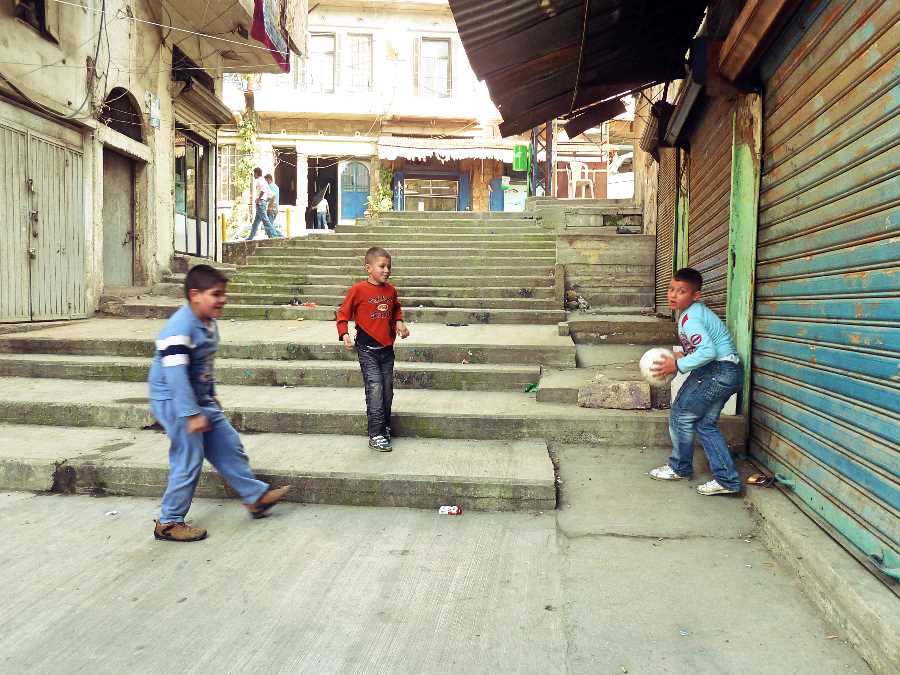 Boys play football in the streets of Tripoli, Lebanon