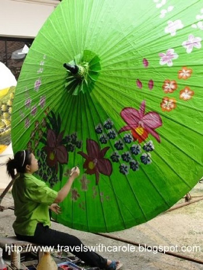 This woman is putting the finishing touches on a huge umbrella at the Umbrella Making Centre in Borsang Village in Sankamphaeng, Thailand.