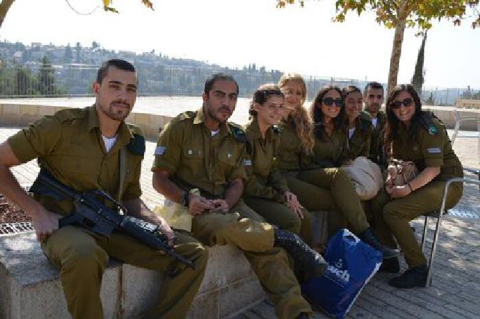 Israeli teen soldiers in Jerusalem take a break from patrolling the streets.
