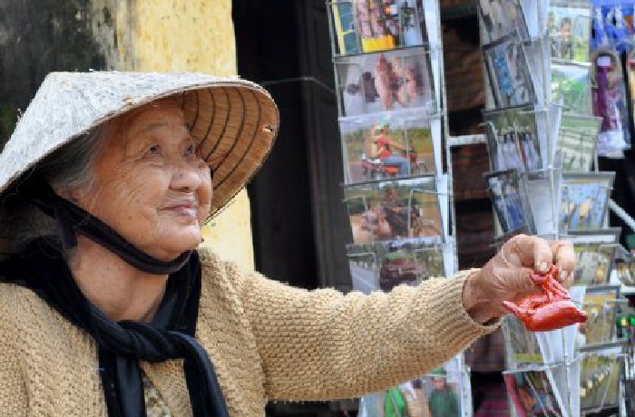 This old woman had set up her stall and was selling clay whistles at the side of the road in Hoi An, Vietnam.